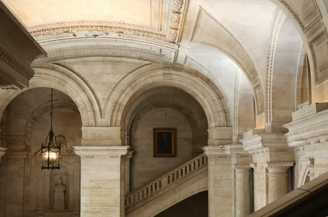 Historic library hall with arched ceiling and bookshelves